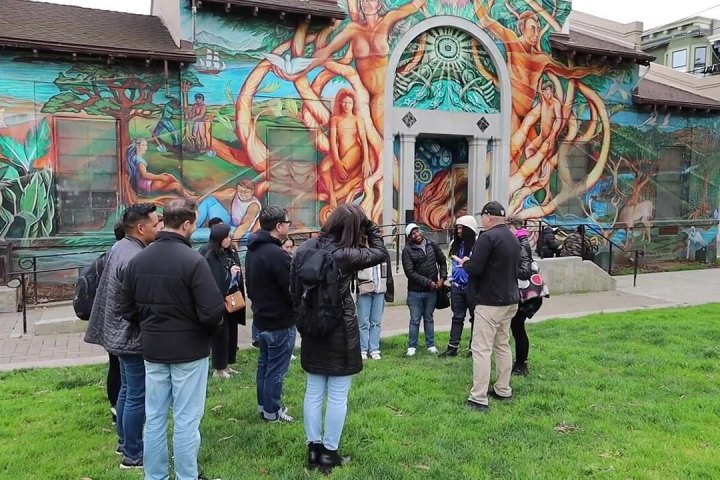 Guests viewing a mural on the Mission District Food Tour