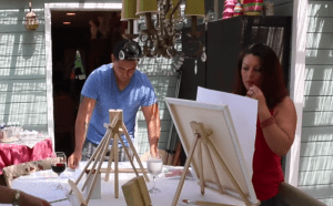 people painting on a canvas