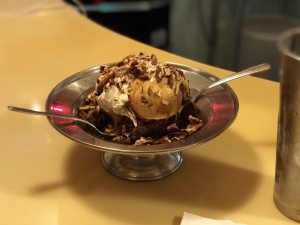 A large bowl of ice cream with two spoons