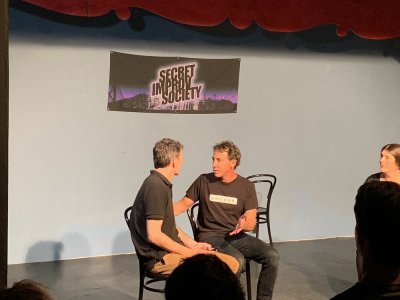 2 people on stage at an improv class