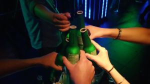 people tapping their beers together