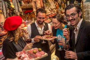 People enjoying samples of food on a food tour
