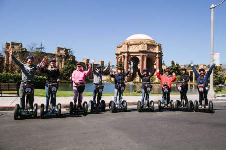 people standing on segway scooters