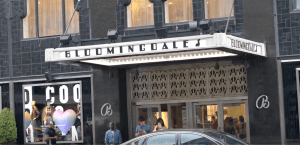 a street sign in front of a Bloomingdales store
