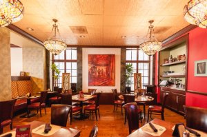 a living room filled with furniture and a fire place and a dining table