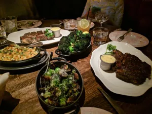 a pizza sitting on top of a plate of food on a table
