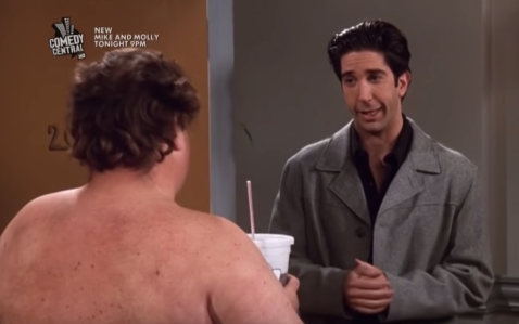 David Schwimmer looking at the camera and a naked man with his back to the camera