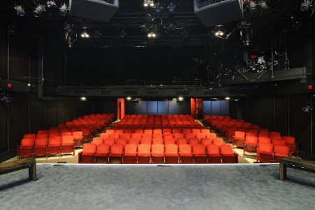 an auditorium of red seats