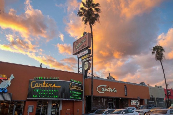 a sign above a store in a parking lot