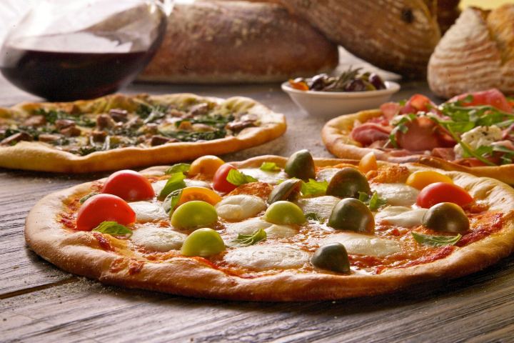 a pizza sitting on top of a wooden cutting board