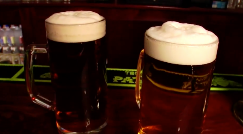 two full beer mugs on a table