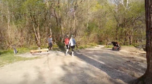 a group of people walking and a baby carriage on the right
