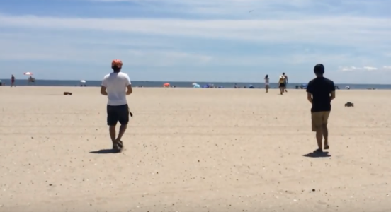 a beach with people in the foreground and background