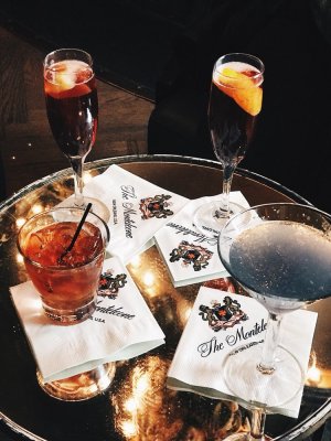 a tray with four cocktail glasses on a table