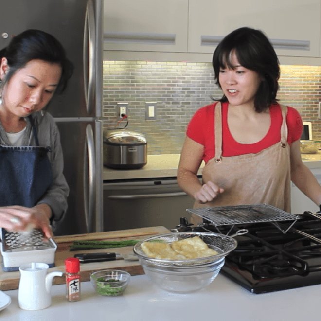 two women cooking in a kitchen