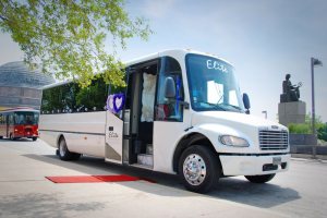 a white party bus that is parked on the side of a road
