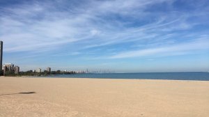 a sandy beach next to a body of water