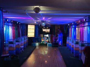a dark room set up with a stage set up for a game show