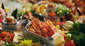 a close up of a bowl of seafood and greens