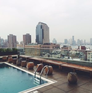 a rooftop pool overlooking a city