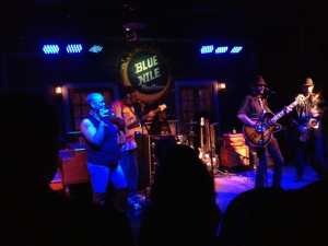 a group of people performing on stage in front of a crowd