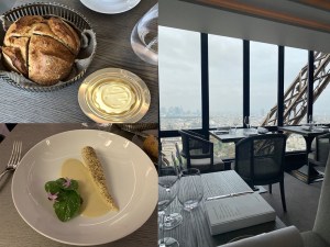 a table in front of glass widows and plated dishes
