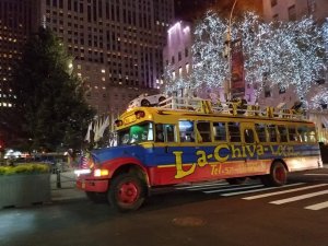 a colorful school bus parked in front of a large building