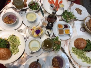 a large table filled with plates and dishes of various foods and dips