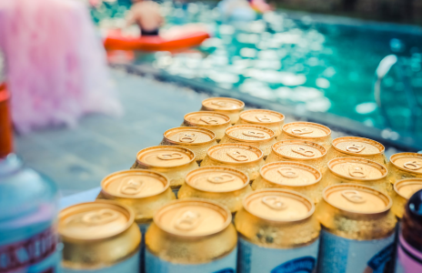 beers with a pool in the background