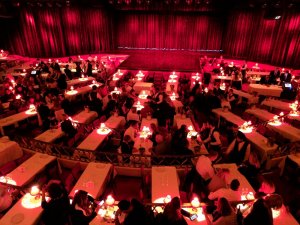 a large theatre with lit tables