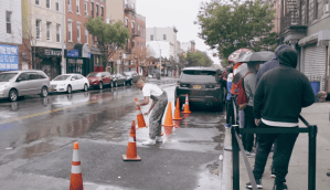 a man moving traffic cones along a city street