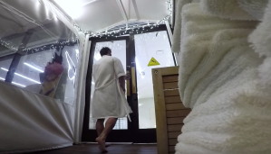 a man leaving a spa with a white robe on