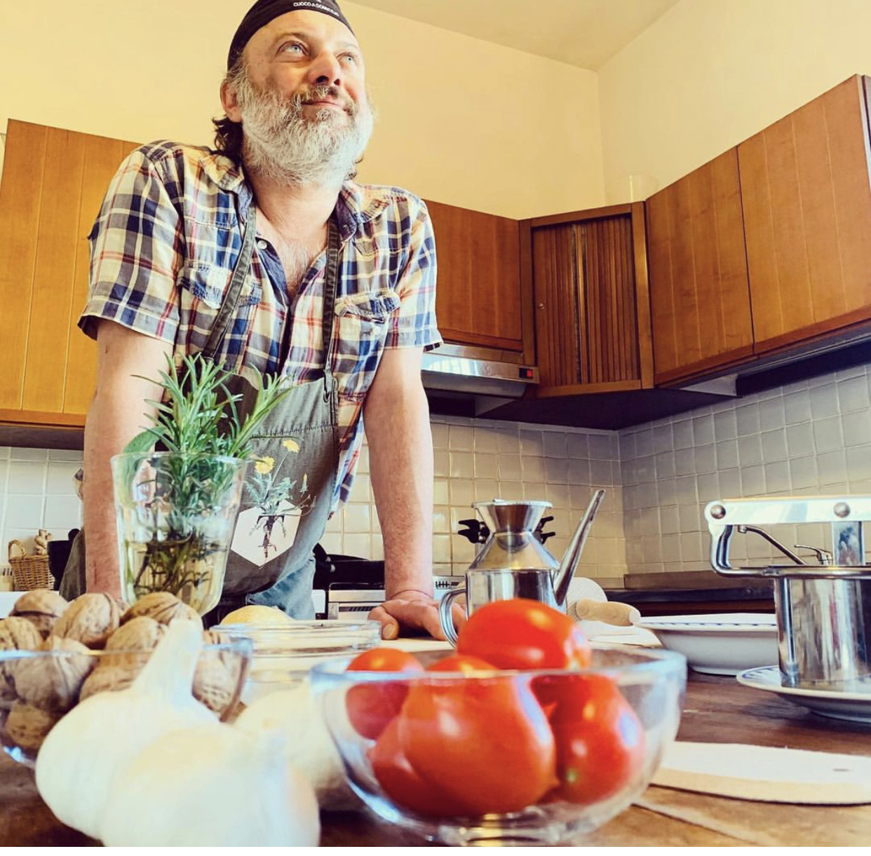 a man sitting on a kitchen counter preparing food