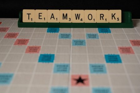 scrabble board game with the word teamwork