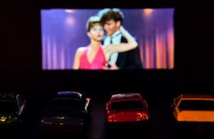 a romantic movie on the big screen at the theater