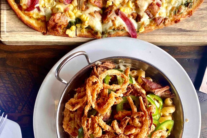 a pizza sitting on top of a plate of food