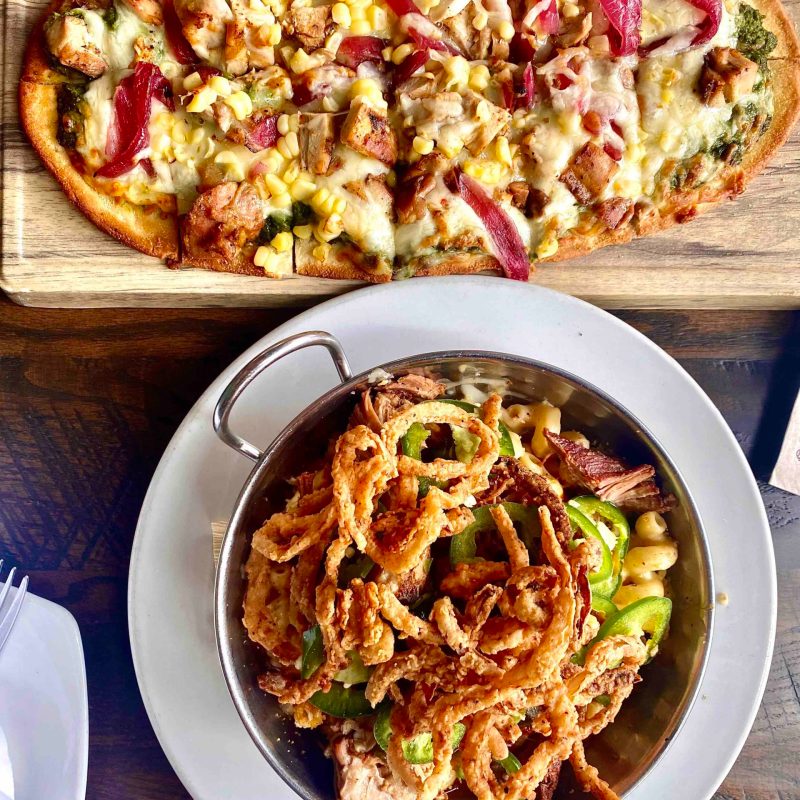 a pizza sitting on top of a plate of food