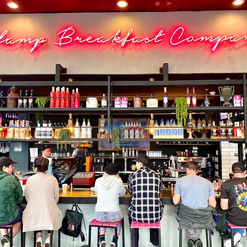 a group of people standing in front of a store