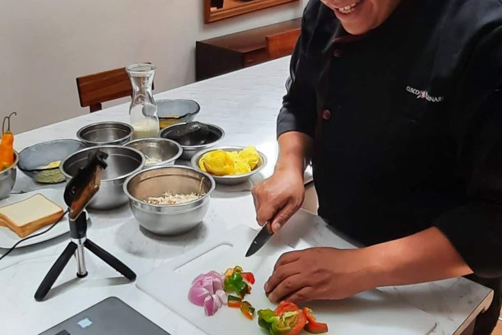 a person sitting at a table using a laptop