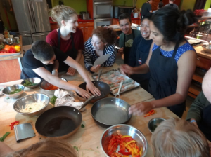 a group of people sitting at a table eating food