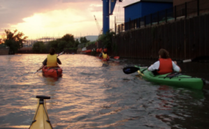 a group of people kayaking down the Chicago River