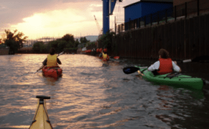 a group of people kayaking down the Chicago River