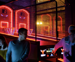 people shooting hoops on a light-up basketball arcade game
