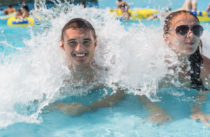 Two teenagers in a wave pool at a waterpark