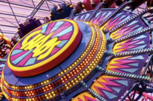 spinning wheel ride that is brightly colored with yellow, pink, purple, and blue pattern