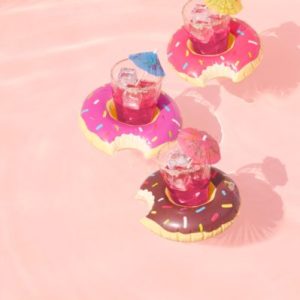 tropical drinks with paper umbrellas, floating in donut floaties