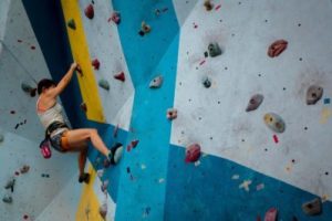 a person rock climbing on a boulder wall