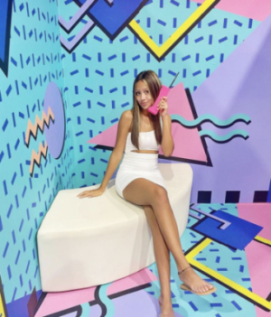 A girl talking on the phone at the Selfie Galleries walls in Austin, TX