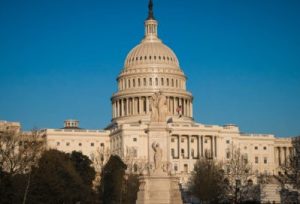 The United States Capitol during a day with blue skies