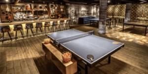 SPIN event space with ping pong tables, a bar, and dimmed lights